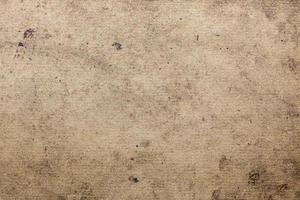 dirty flat cardboard surface texture and background with black spots of oil and technical pollutions photo