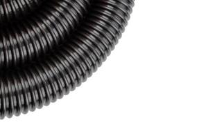 black plastic corrugated vacuum cleaner hose on white background photo