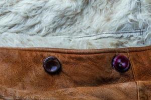 small brown thick seude jacket with white sheep fur lining closeup texture with selective focus and blur photo