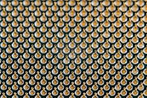 Close-up full frame view of gold plated microprocessor pin array. Abstract electronic tech backdrop with selective focus photo