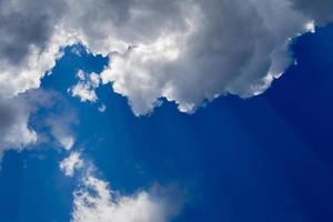 Regular spring clouds on blue sky at daylight in continental europe. Close shot wit telehoto lens and polarizing filter. photo