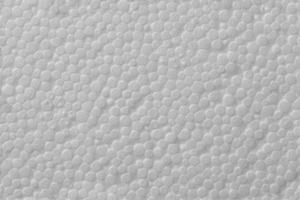 Simple texture of white polystyrene foam or styrofoam, close-up flat white on white background photo