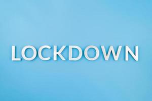 the word lockdown laid with brushed aluminium metal letters on blue background photo