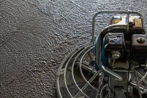 Wet concrete grinding trowel machine - close-up with selective focus photo