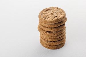 stack of round chip cake cookies with chocolate on white surface background photo
