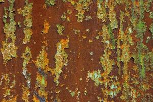 flaked off green paint on flat rusted sheet metal surface photo