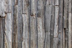 Fondo y textura de la superficie de la pared de tablones de madera desordenados grises foto