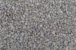 Dry white limestone ballast flat full frame background. Small gray dusty broken macadam stones texture. photo