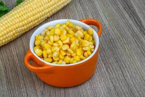 Sweet corn in a bowl on wooden background photo