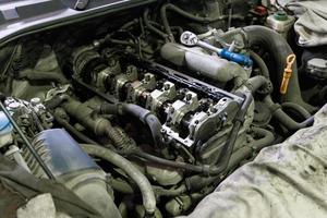 opened diesel internal combustion engine durnig repair inside engine compartment of SUV photo