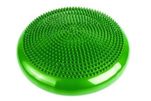 Green inflatable balance disk isoleated on white background, It is also known as a stability disc, wobble disc, and balance cushion. photo