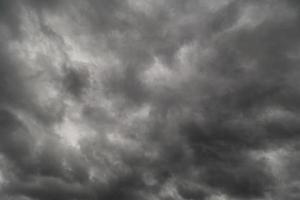 dramatic grey storm clouds background upward view from ground photo