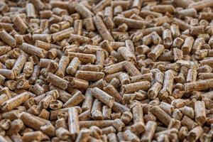 wooden sawdust pellets. Litter for pets and bio fuel, full frame background. photo