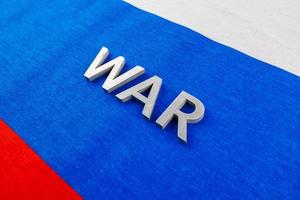 the word war laid with silver metal letters on Russian Federation tricolor flag photo