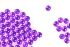 proton purple spherical ball capsules with selective focus isolated on white background photo