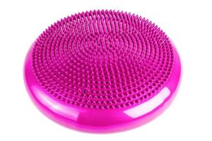 Pink inflatable balance disk isoleated on white background, It is also known as a stability disc, wobble disc, and balance cushion. photo