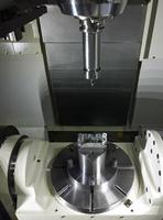 The five-axis Computer Numerical Control CNC machine waiting for stock change photo