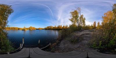 Full spherical 360 by 180 degrees panorama of evening autumnal lake with birch forest on its shores photo