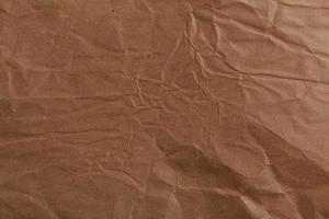 Ragged crumpled brown kraft paper texture and full frame background photo