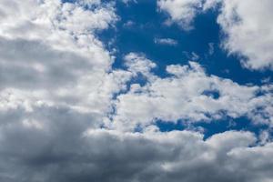 Regular spring clouds on blue sky at daylight in continental europe. Close shot wit telehoto lens and polarizing filter. photo