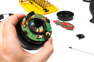 Left hand repairing camera lens photo