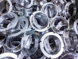 a batch of machined shiny aluminium parts with selective focus photo