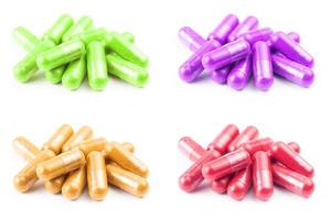 set of of colored organic capsules isolated on white background closeup with selective focus photo