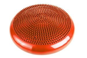 orange inflatable balance disk isoleated on white background, It is also known as a stability disc, wobble disc, and balance cushion. photo
