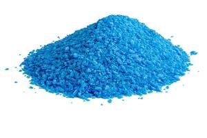 pile of blue copper sulfate granules - close-up isolated on white background photo