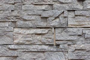 fake stone wall, plastic panel imitating natural slab wall brickwork photo