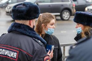 TULA, RUSSIA  JANUARY 23, 2021 Public mass meeting in support of Alexei Navalny, pretty underage girl argues with the police. photo