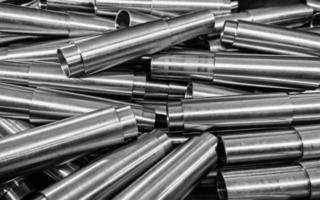 steel cnc-turned raw surface pipes closeup industrial background photo