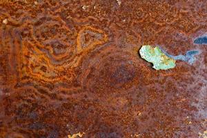 artisticly rusted flat iron surface with leftowers of peeled off paint photo