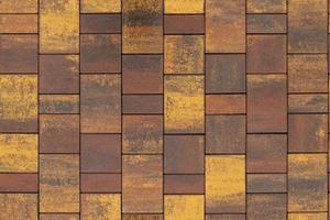 seamless texture and background of brown and yellow melange rectangular artificial stone pavement photo