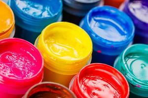 full-frame close-up background of opened small gouache paint jars photo