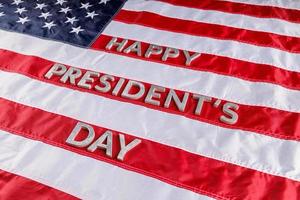 words happy presitdents day laid with real letters on US flag surface photo