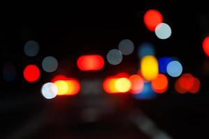 defocused night street view from drivers perspective photo