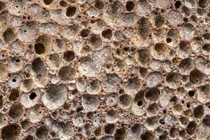 macro shot of used pumice stone with dirt and dead skin inside pores photo