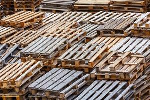 full frame background of used wooden pallet stacks - perspective view from above photo