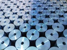 abstract background of shiny steel cylinder parts with central hole photo