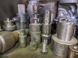 A lot of old rusted machining stock holders dark industrial back photo