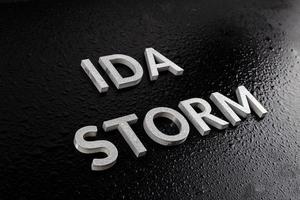 the words ida storm laid with silver metal letters over black surface both covered with rain water drops photo
