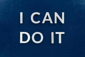 the words i can do it laid with white metal letters on dark blue flat background photo