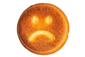 unhappy face biscuit cookie isolated on white in flat lay perspective photo