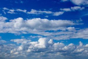 Regular spring clouds on blue sky at daylight in continental europe. Shot wit telephoto lens and polarizing filter. photo