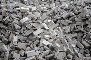 Pile of disassembled gray pavement bricks with selective focus photo