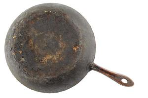 old stained rusty cast iron pan with burnt fat isolated on white bottom up in flat lay perspective photo