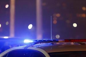 police car lights at night in city with selective focus and bokeh photo