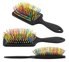 set of different views on new rainbow colorful pastic hair brush isolated on white background photo