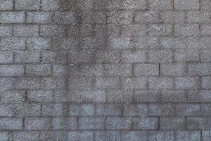 wall of cinder blocks covered with a layer of shagreen concrete plaster photo